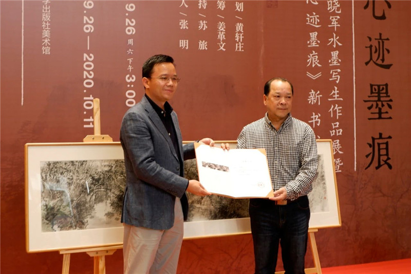 5集團公司黨委副書(shū)記、總編輯湯文輝代表廣西師范大學(xué)出版社集團接受白曉軍先生的藝術(shù)作品捐贈.jpg